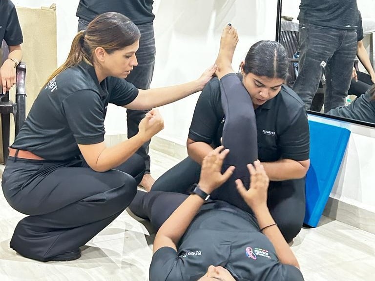 Dr. Verna D'Silva performing hands-on manual therapy and joint mobilization