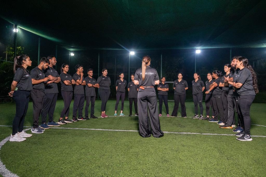 Sports physio team briefing on turf by Dr. Verna D'Silva